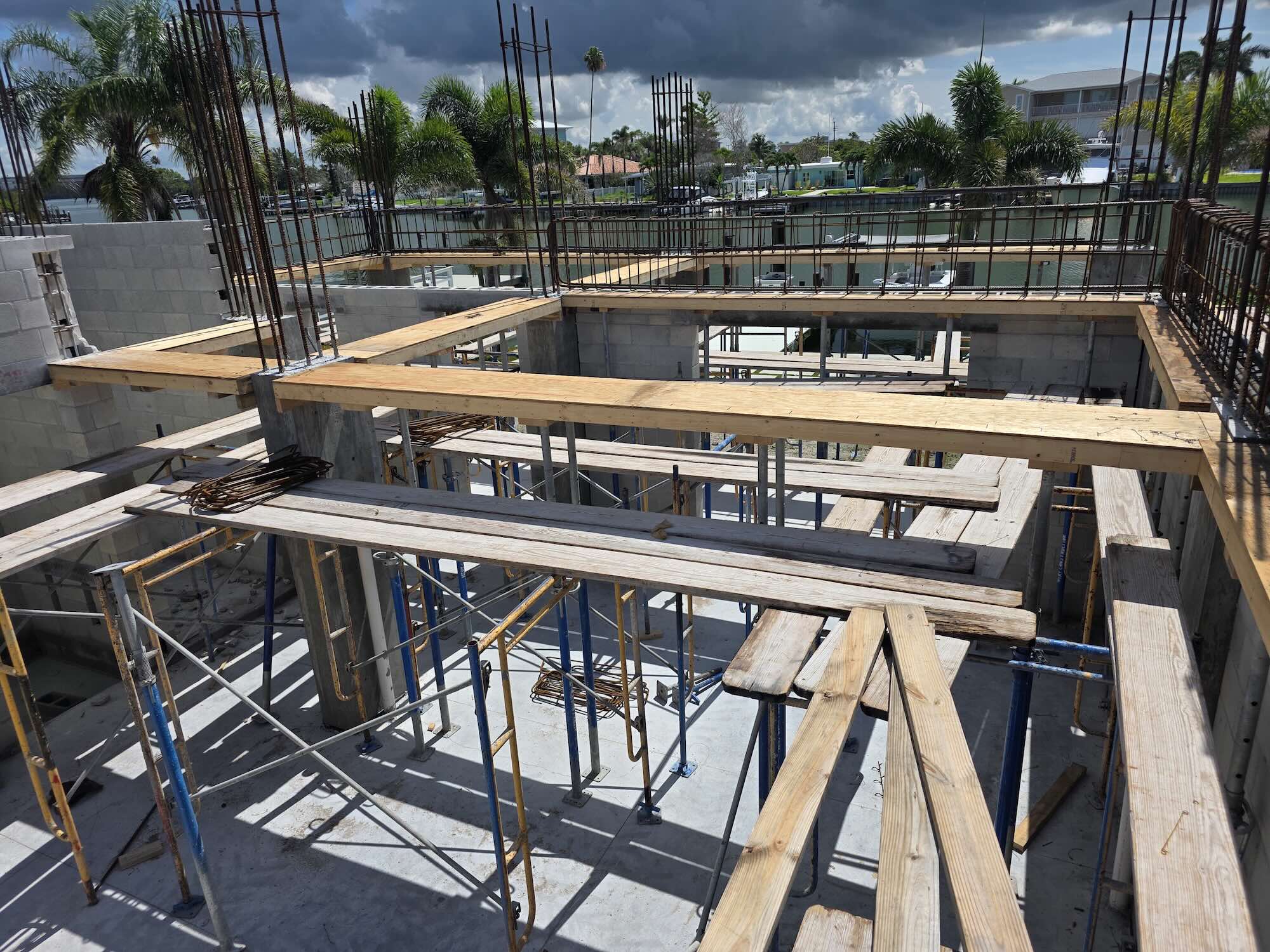 Wide view of wood formwork and shoring for an elevated concrete floor at a waterfront job site