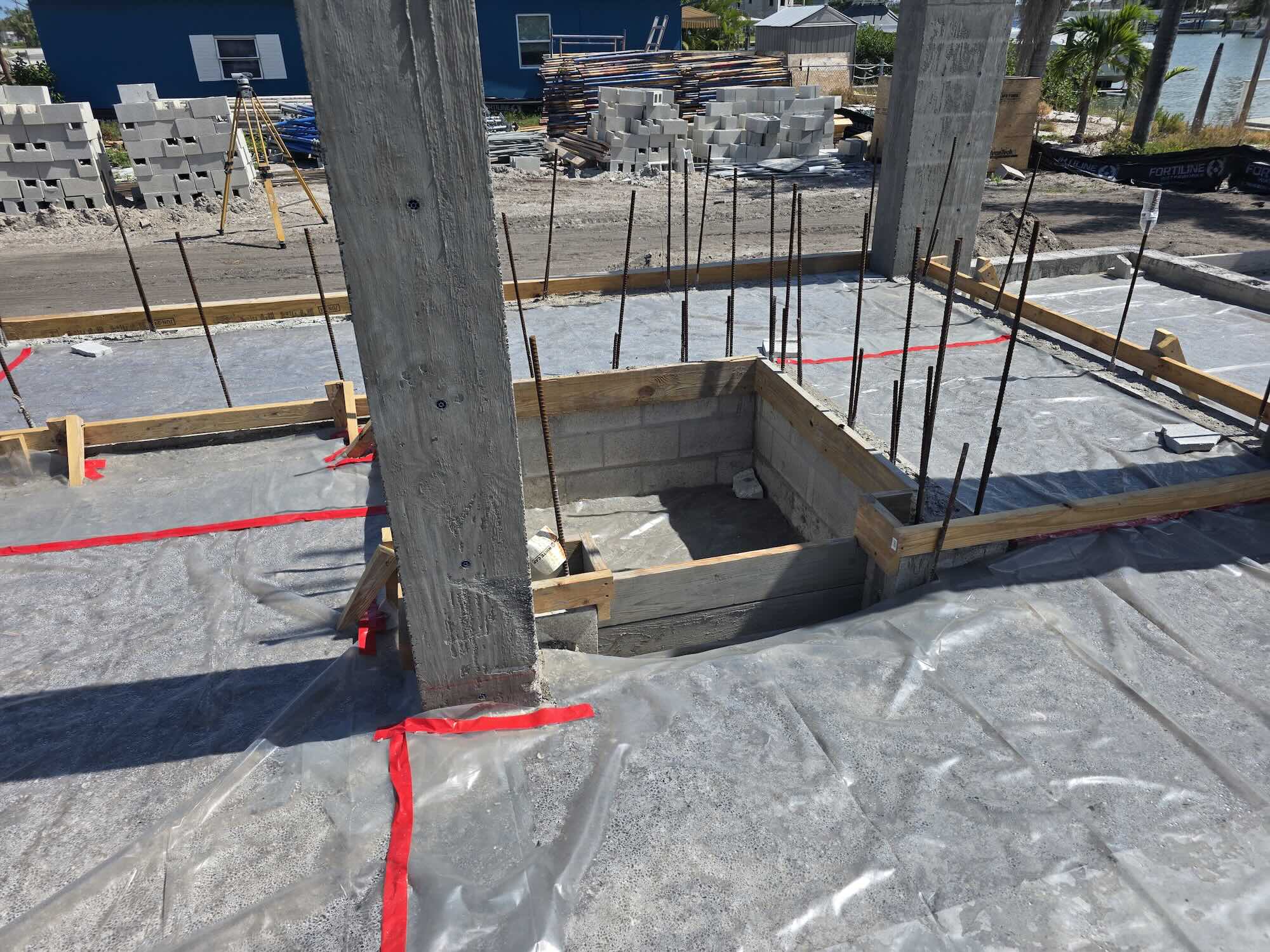 Elevated concrete slab under construction with a recessed formed pit and protruding rebar dowels